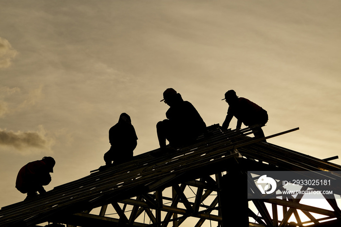 Contractor in Silhouette working on a Roof Top