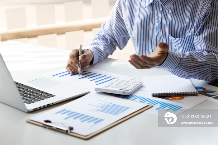 A businessman that operates on the table being checking data, Concept financial transactions online of a businessman, Financier being check about financial transaction past computer with teamwork.