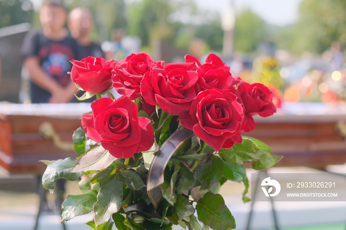 Beautiful funeral wreath of roses at coffin