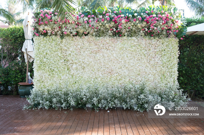 Wedding backdrop decorated with flowers on wooden ground