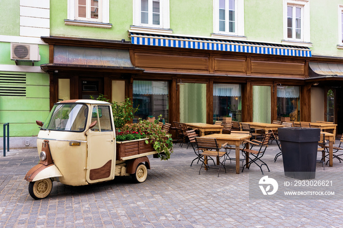 Cityscape with street cafes at Celje old town in Slovenia. Architecture in Slovenija. Travel. Tables and chairs.