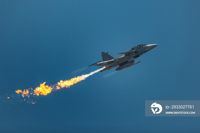 Jet fighter in the sky with fire flame