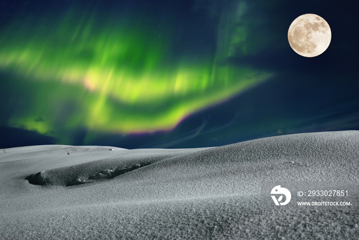 Aurora borealis over frosty winter night field with fool moon in the sky