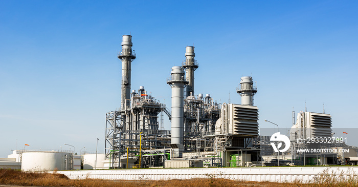 Power plant station building and industrial pipe system on blue sky background