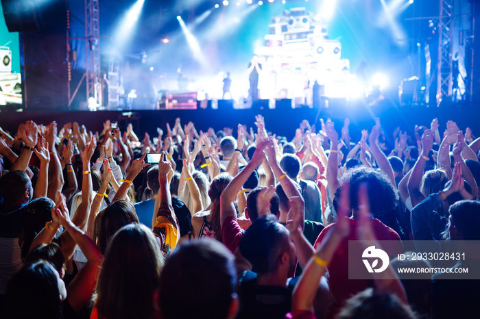 Crowd raising their hands, dancing and enjoying great the concert. Summer holiday, vacation