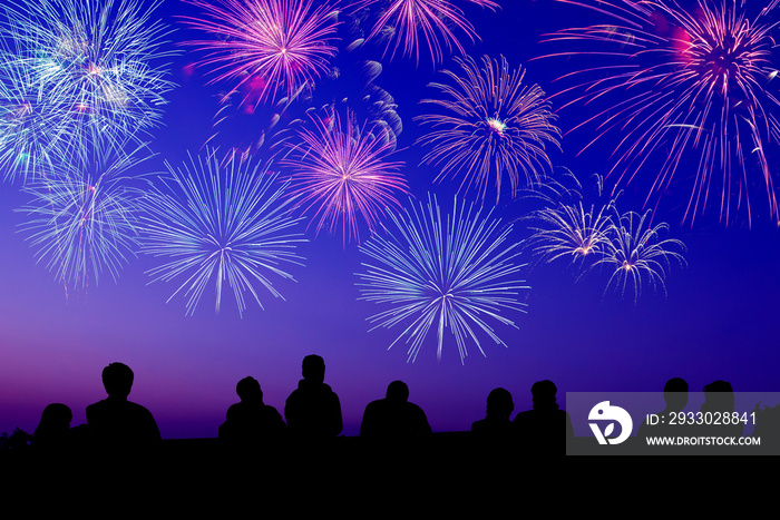 Big fireworks with silhouettes of people watching it