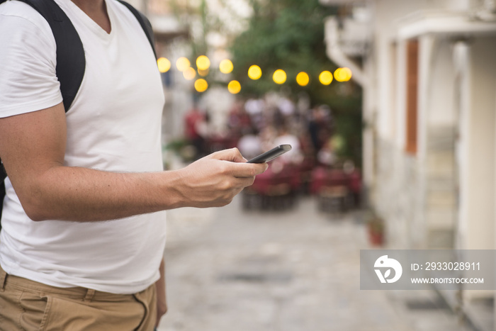 Young urban professional man using smart phone. Businessman hold