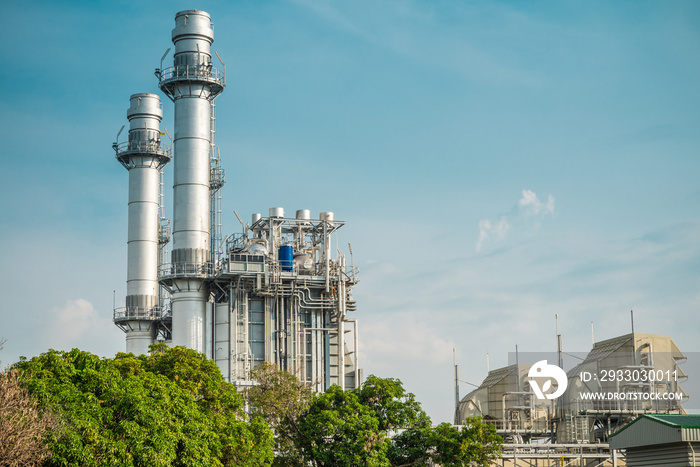 Natural gas electric power plant with blue sky sunny day background. Electricity, energy technology concept.