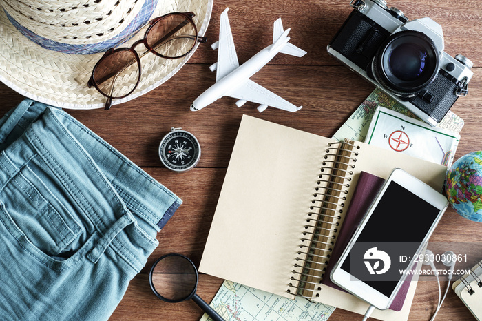 Outfits and accessories of traveler on wooden background