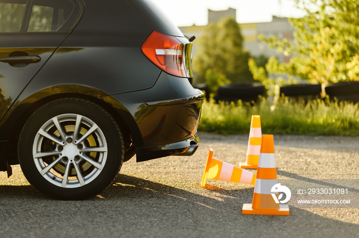 Car and traffic cones, driving school concept