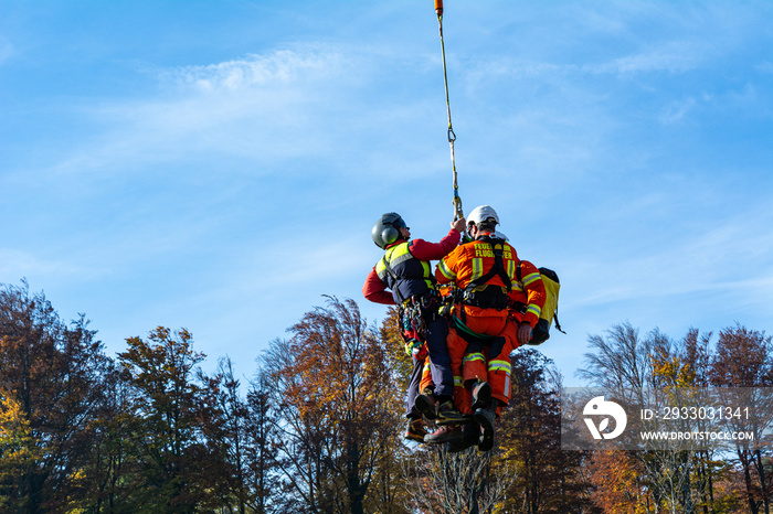 A Group of Rescue Service Members to be transported with a Helicopter to a forest fire in Lower Austria