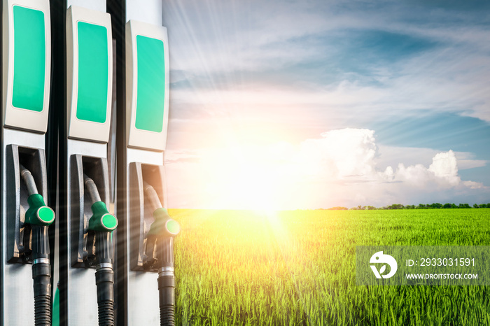 Several fuel dispensers in a gas station against a background of nature: the concept of fuel and eco-fuel prices