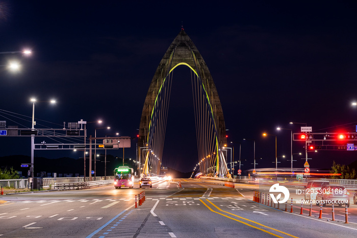 Scenic view of cars and light trails during sunset