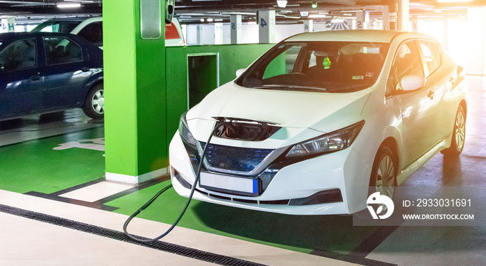 Eco auto. Electric car charge battery on eco energy charger station. Hybrid vehicle - green technology of future. Clean energy future of transportation ecology concept.