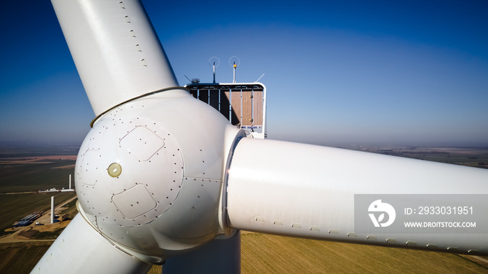 Aerial view of close up windmill turbine in countryside area, Wind power and renewable sustainable energy concept