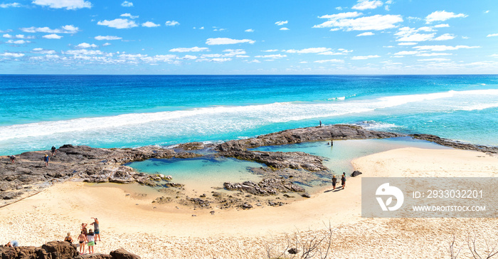 the beach near the rocks in the wave of  ocean