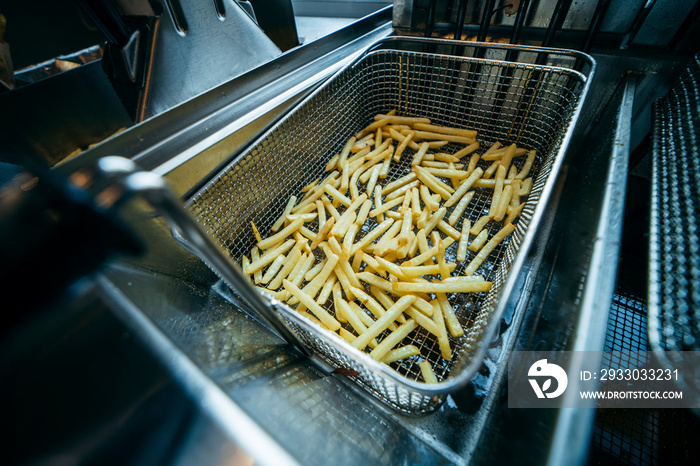 Deep fryer for potatoes in kitchen