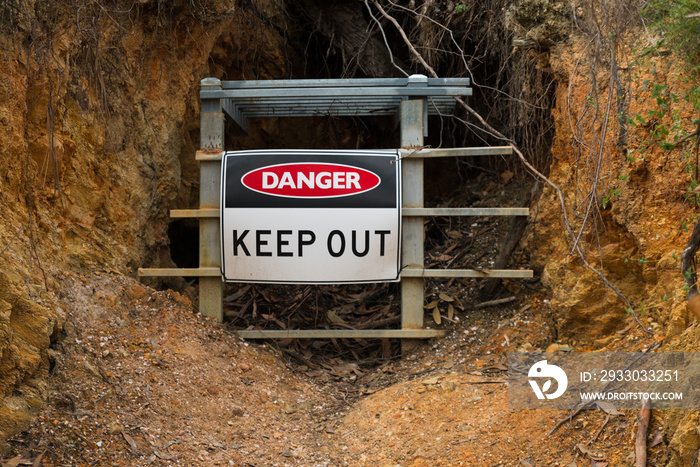 Danger Keep Out safety warning sign in front of closed gold mine Jupiter Diggings in Adelaide Hills South Australia