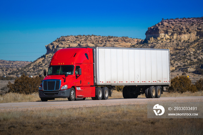 Eighteen wheel big rig tractor with trailer on highway. Trucking industry