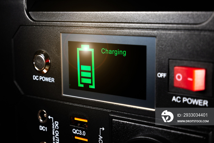 Control panel display of lithium Portable Power Station. Charging laptop smartphones, power banks and other gadgets. Modern, information technology.