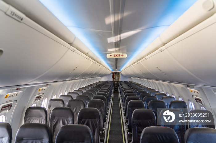 inside a modern single aisle passenger airplane cabin with empty economy seat in grey color - no passengers onboard