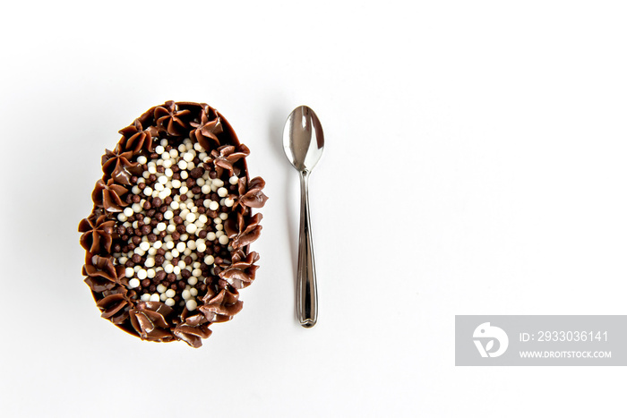 Delicious spoon egg stuffed with chocolate, Brazilian easter egg on white background.