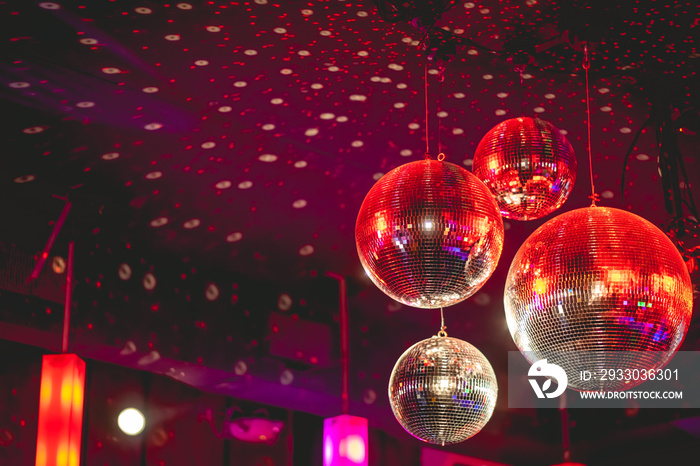 Disco balls with light reflections in the mirrors in a celebration in a big disco (with copy space)