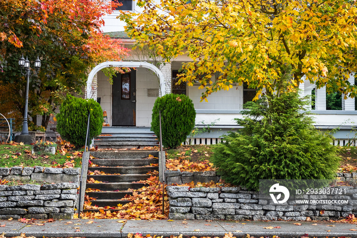 Autumn leaves, front porch of an old wooden home