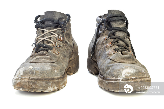 worn-out old work boots isolated on white background