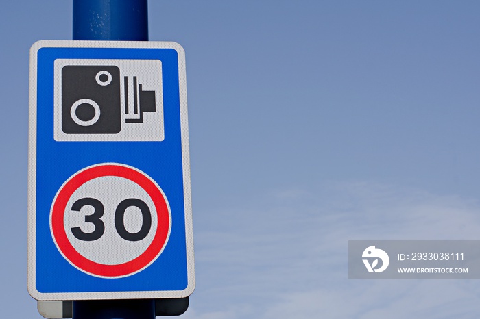 UK road sign 30mph speed limit sign with a speed camera warning.