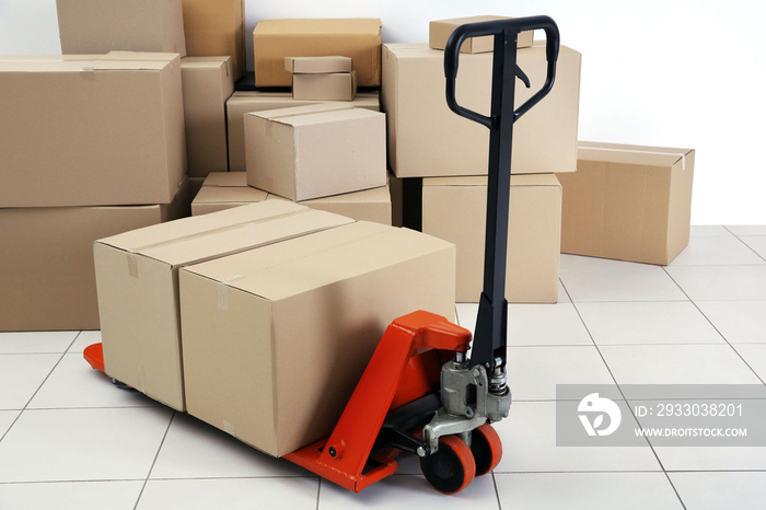 Manual pallet truck with carton boxes indoors