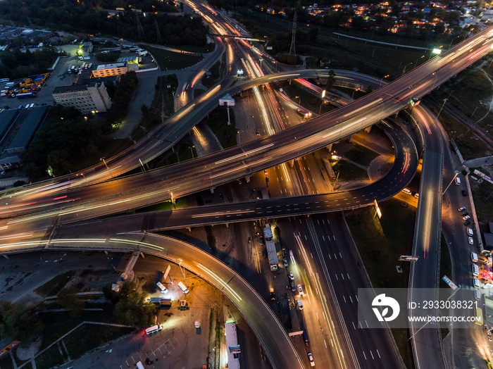 Traffic on freeway interchange. Aerial night view city traffic.