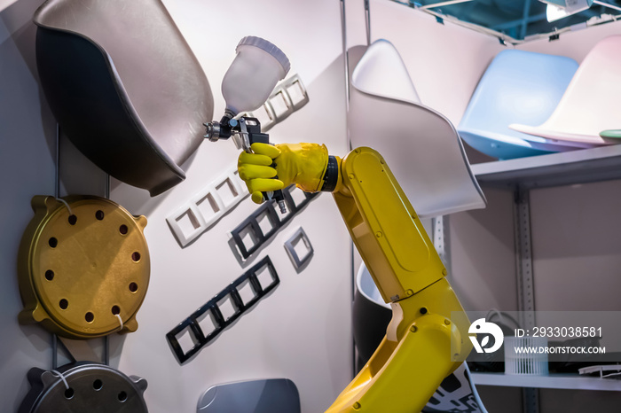 Automatic yellow spray painting robotic arm manipulator demonstrates functionality at smart robot technology exhibition, trade show. Manufacturing, futuristic, production concept