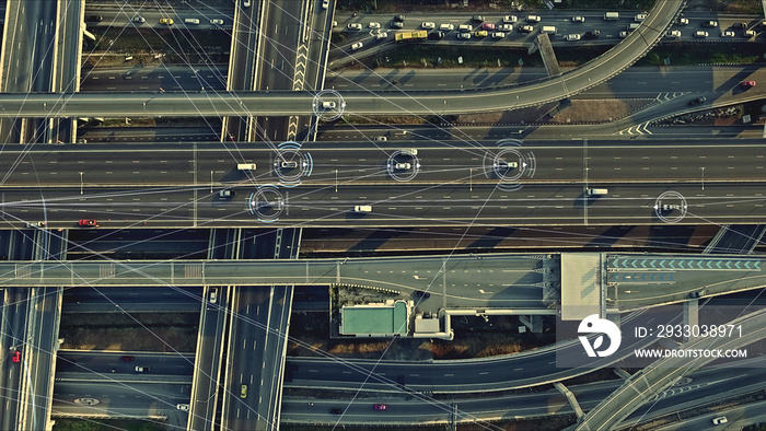 Aerial view from above of traffic on the elevated expressway with futuristic autonomous, driverless cars using artificial intelligence computer network and satellite gps for navigation