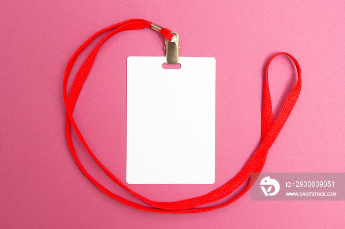 Blank badge mockup isolated on pink background. Plain empty name tag mock up with red string.