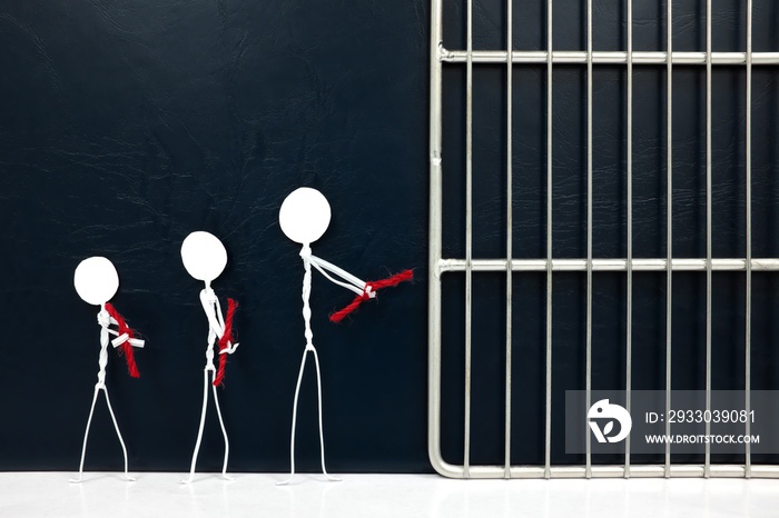 Young stick man figure handcuffed tied with red rope going to a jail prison in dark background. Lowering age for criminal liability responsibility, minors, youth and juvenile crime, justice concept.