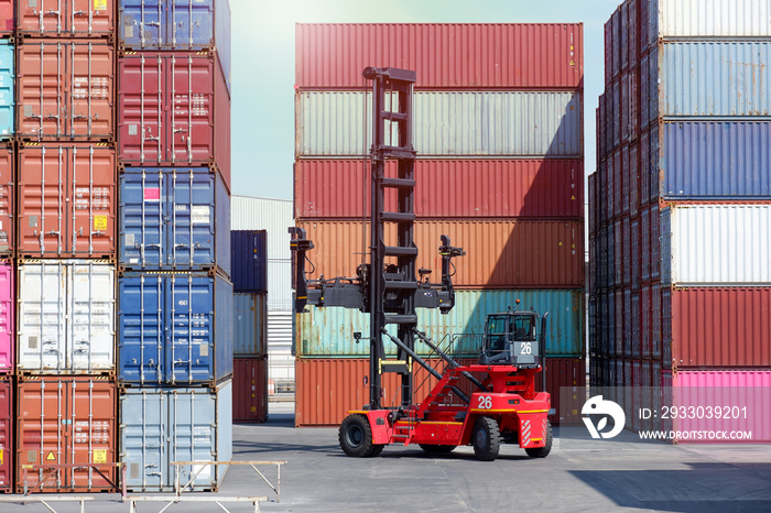 forklift truck Container boxes in a logistics yard with a stack of containers in the background.