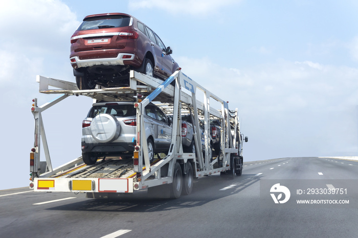 Trailer transport cars on the highway.Truck on highway road container, transportation concept.,import,export logistic industrial Transporting Land transport on the expressway.soft focus of cars