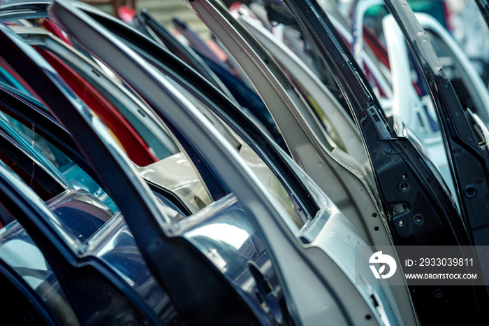 different colored car doors at a car junkyard