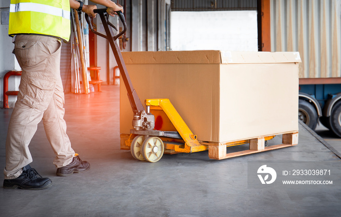 Workers Courier Using Hand Pallet Jack Unloading Package Boxes Pallet into Cargo Container. Delivery Shipment . Trucks Loading at Dock Warehouse. Supply Chain. Warehouse Shipping Transport Logistics.