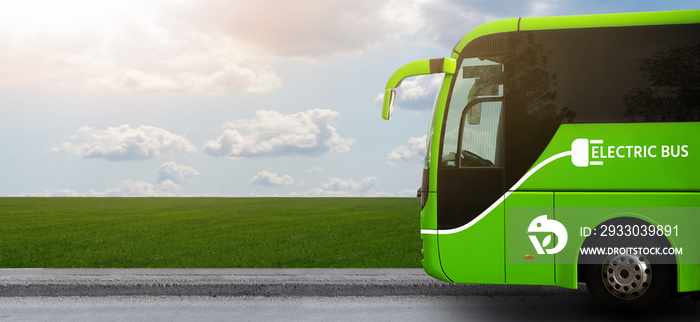 Electric tourist bus on a background of green field