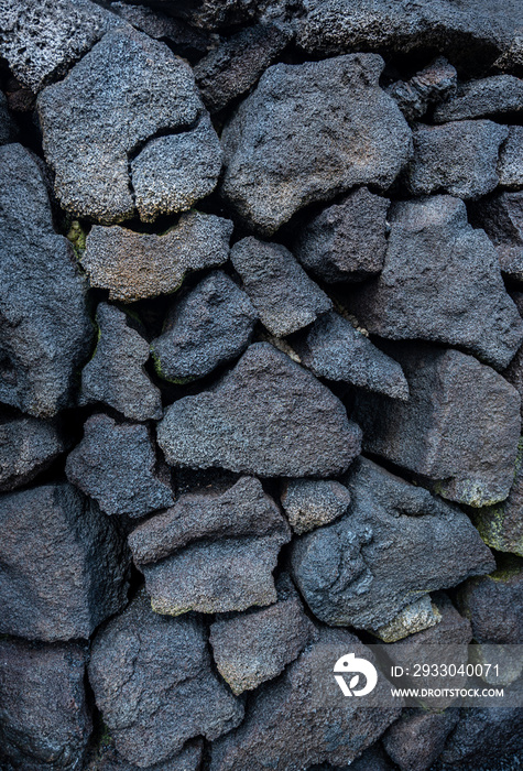 Vertical shot. Black stone wall, volcanic stone background