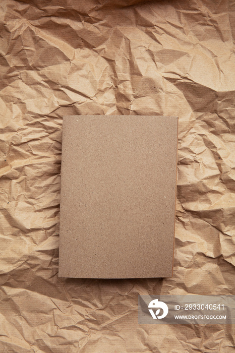 Blank invitation letter template mock up on crumpled brown paper