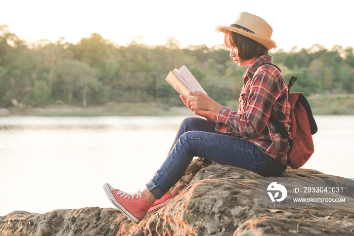 Pretty relaxed young woman reading a book in quiet nature, concept read a books.