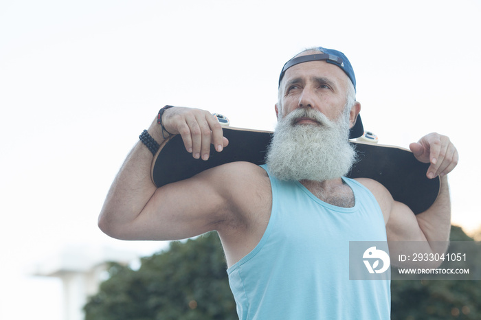 energetic senior man enjoying riding a skateboard