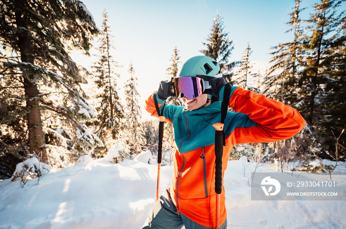 Mountaineer backcountry ski walking ski alpinist in the mountains. Ski touring in alpine landscape with snowy trees. Adventure winter sport. High tatras, slovakia landscape