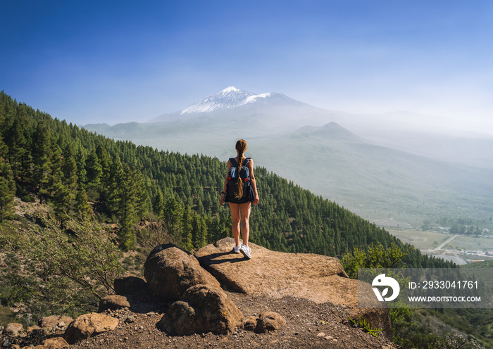 Young woman hiking on the volcano Teide, Tenerife, Spain