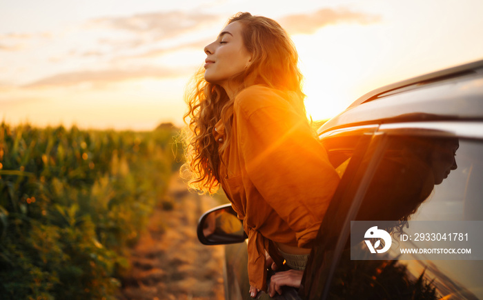 Towards adventure! Young woman is resting and enjoying the trip in the car.  Lifestyle, travel, tourism, nature, active life.