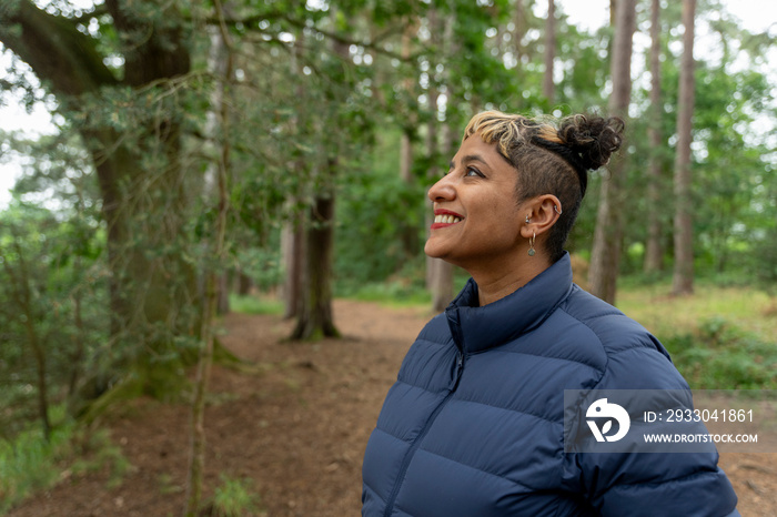 Smiling mature woman hiking in forest