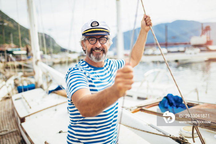 Handsome senior man traveling on sailboat